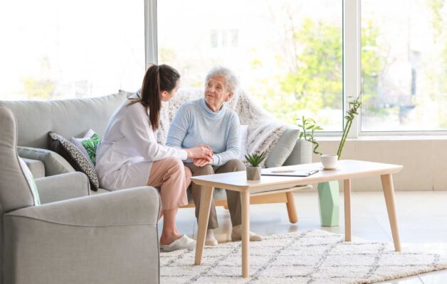 compassionate nurse holding an older adult's hand